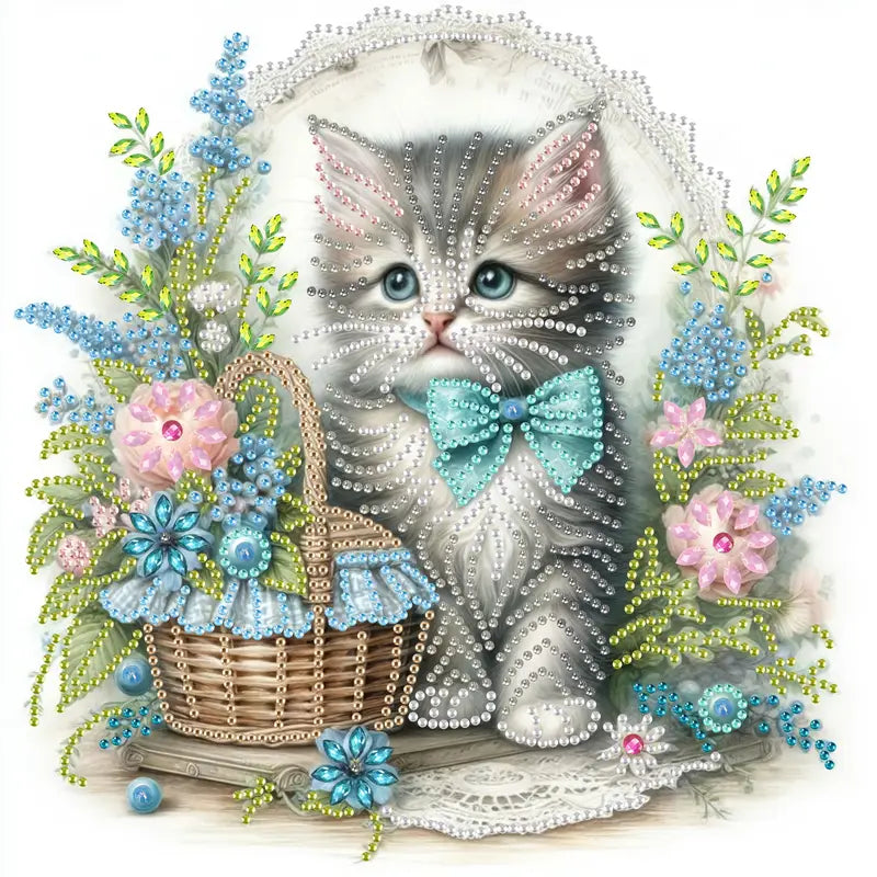 Partial diamond painting kit of a grey and white kitten with blue eyes and a blue bow tie, sitting next to a basket of pink and blue flowers. The design is made with crystal and special shape rhinestones.