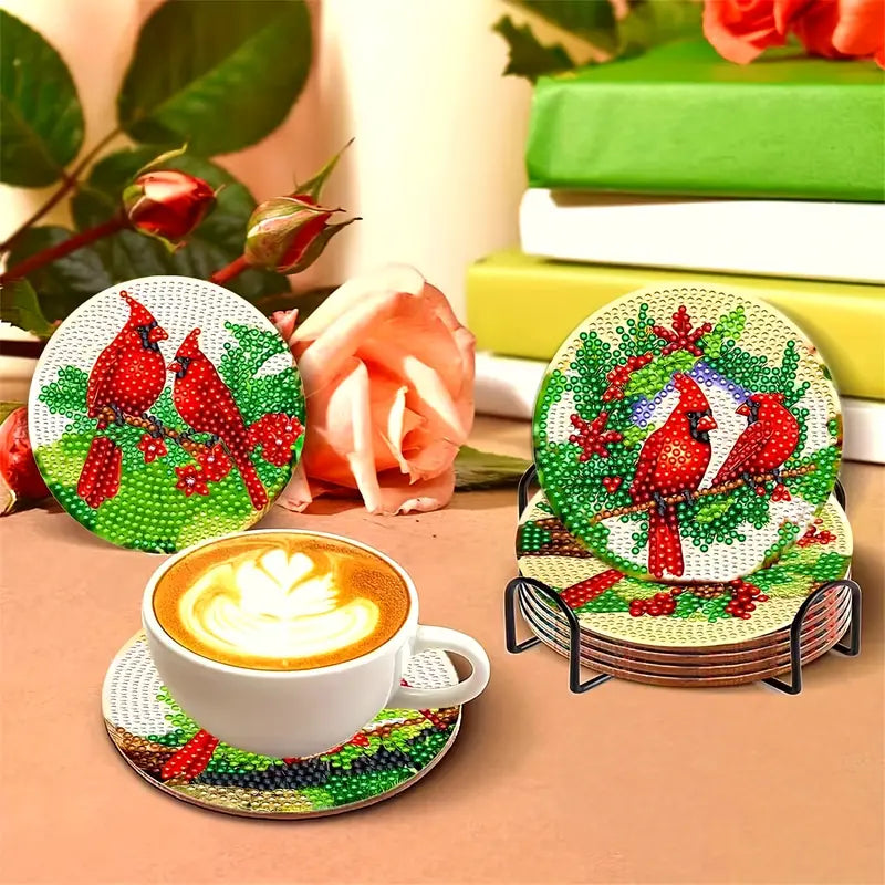 Set of Christmas-themed coasters with red cardinals on a table with a cup of coffee.
