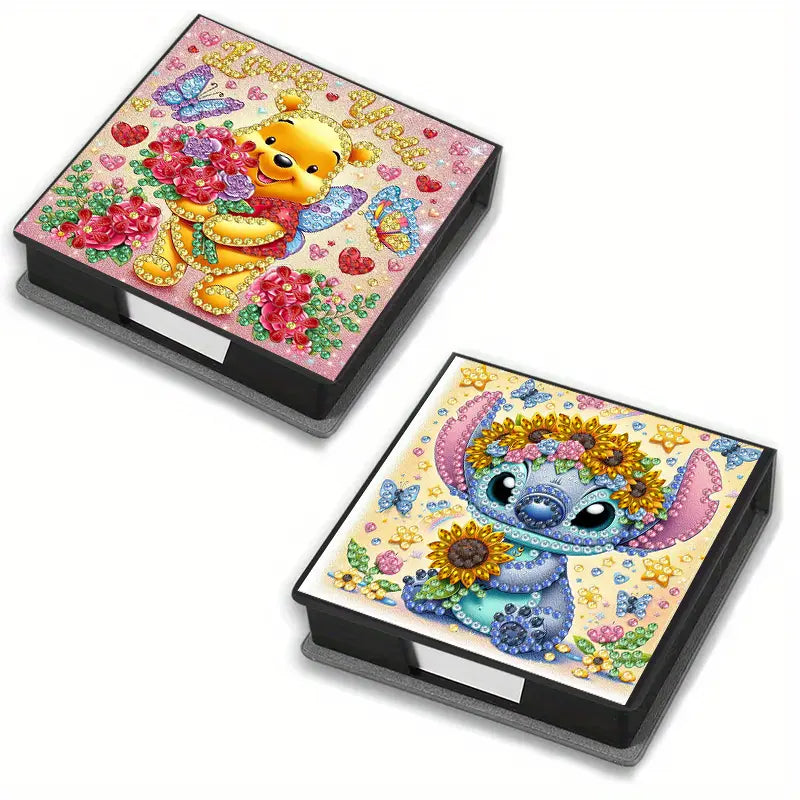 Adorable Character Notepad Diamond Painting Box Kit. Two notepad boxes decorated with crystal rhinestones, one featuring a honey-loving bear with flowers and the other a blue alien with a sunflower crown
