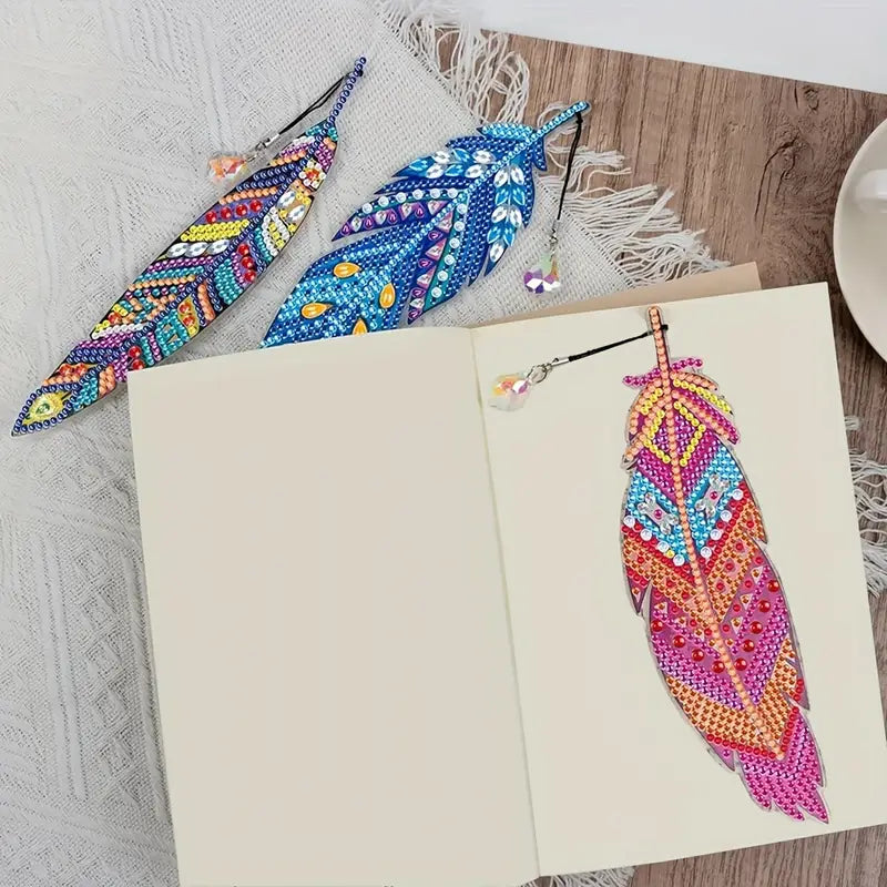 Colorful beaded feather bookmarks on a wooden surface with a book open below.