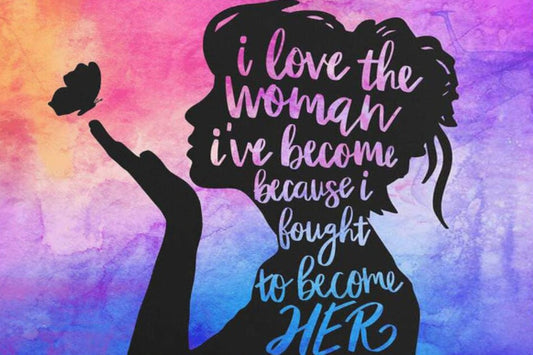 A diamond art kit with a silhouette of a woman's profile against a multicolored background, with the text 'I love the woman I've become because she's become her own woman.'.