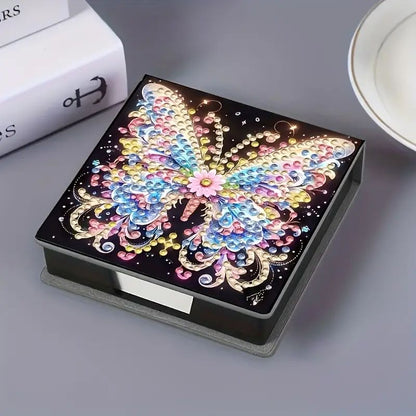 DIY diamond painting note paper holder kit. A black note box with a butterfly design on the lid, ready to be decorated with crystal rhinestones.