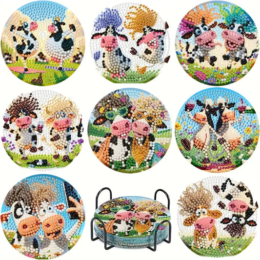 A set of eight completed round diamond painting coasters, each featuring a different whimsical and fluffy cartoon cow, displayed in a black metal holder.