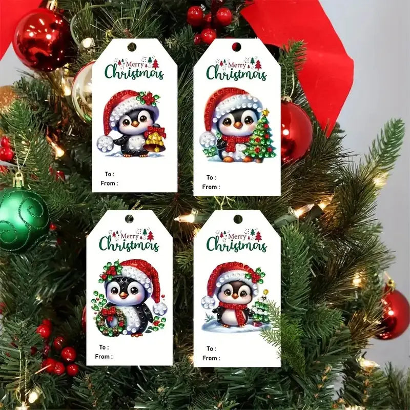 Four Christmas gift tags with penguin designs on a decorated tree background.