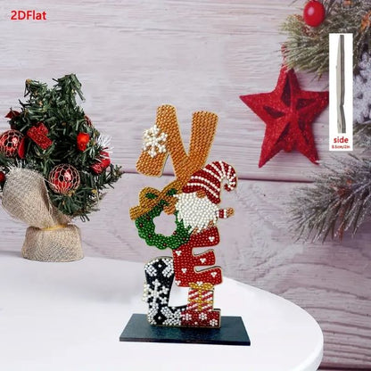 A completed diamond painting tabletop sign that spells NOEL vertically on a dark base, with each letter decorated with Christmas motifs like a gnome, wreath, and snowflakes.