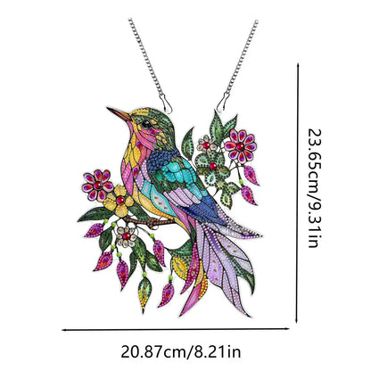 Colorful bird-shaped pendant with floral elements on a white background