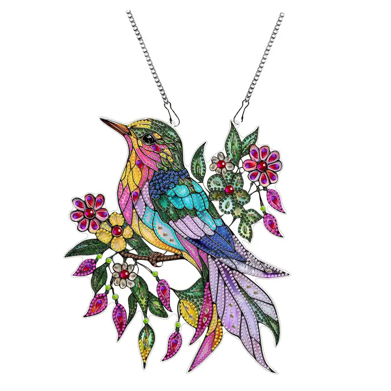 Colorful bird-shaped pendant with floral elements on a white background