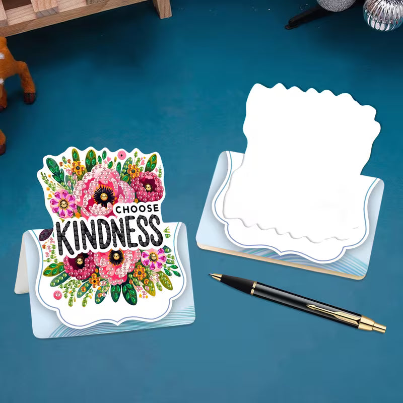 Decorative card with 'Choose Kindness' message on a blue surface with a pen.