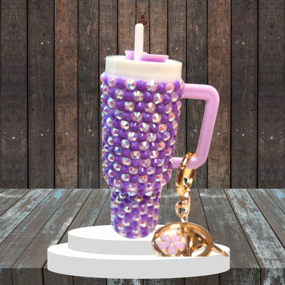 A blinged mini chapstick holder keychain with a purple and silver bead design, featuring a twist-off lid and a keychain attachment.