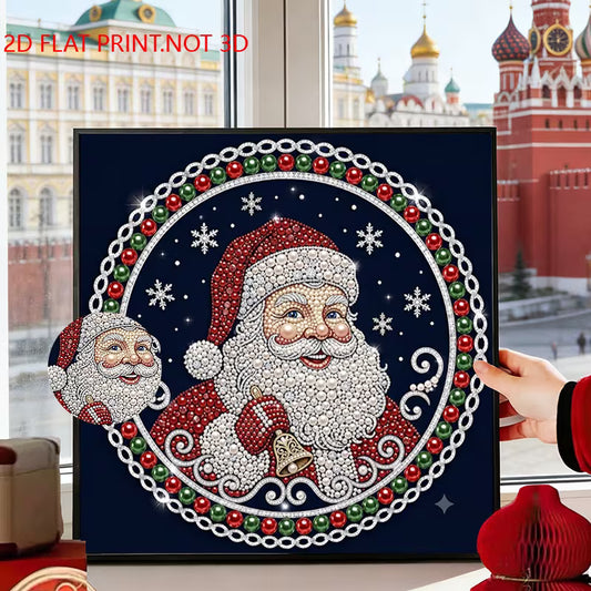 A framed diamond painting or print featuring a festive Santa Claus design in a circular frame, held by a hand near a window with a Moscow cityscape visible outside. The artwork has a dark navy background with red, green, white, and gold details, and the text '2D FLAT PRINT.