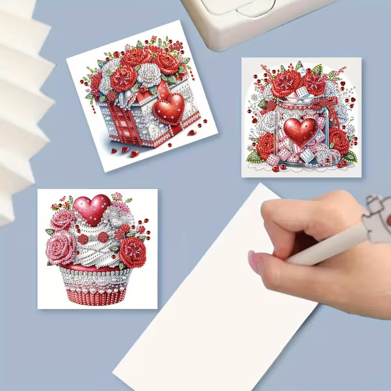Three diamond painting kits with heart and flower designs on a light blue background.