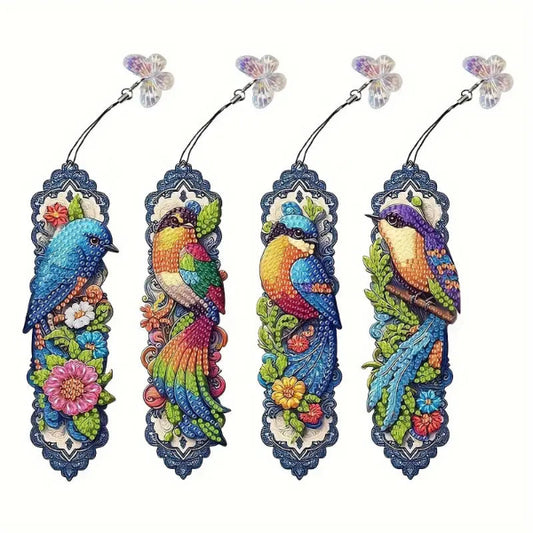 A set of four completed diamond painting bookmarks, each featuring a different colorful bird design with a decorative charm at the top