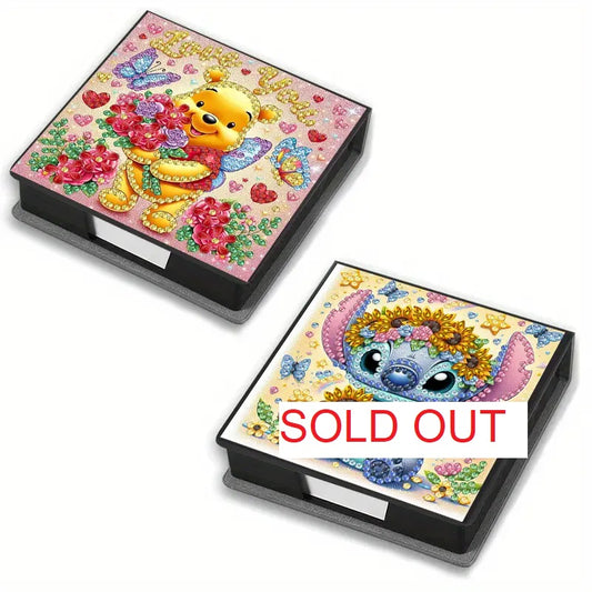 Adorable Character Notepad Diamond Painting Box Kit. Two notepad boxes decorated with crystal rhinestones, one featuring a honey-loving bear with flowers and the other a blue alien with a sunflower crown