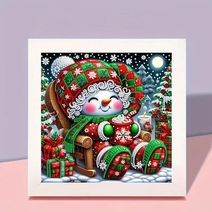 Decorative diamond painting of a snowman with a festive hat and scarf, sitting on a sleigh with presents.