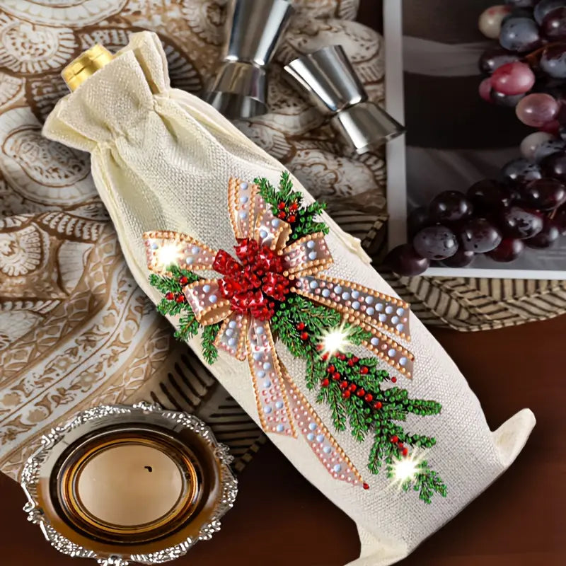 Decorative wine bottle cover with festive design on a table with grapes and a candle.