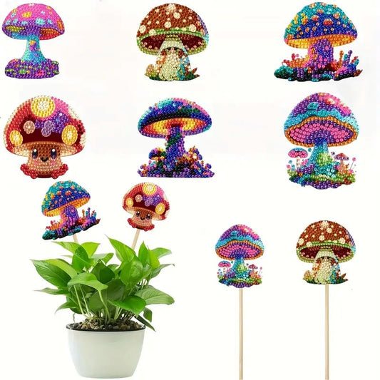 A variety of six completed, brightly colored diamond-painted mushrooms on wooden sticks, one set shown decorating a small green potted plant.