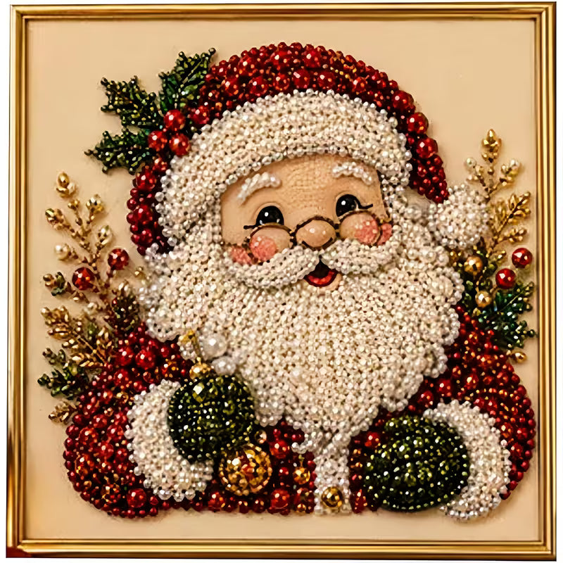 A square framed Christmas beaded portrait of Santa Claus, crafted with white seed beads for the beard and face, red beads for the hat and coat, green holly leaves and ornaments, and gold decorative accents, set against a cream background with a gold frame.